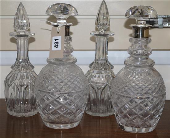 A pair of silver coloured decanters and two others H.29.5cm